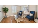 Cozy living room with hardwood floors, two armchairs, and a decorative center table at 8720 E 29Th Ave, Denver, CO 80238