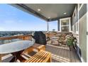 Relaxing outdoor deck with comfortable seating, grill, and scenic views of the surrounding landscape at 1721 Wingfeather Ln, Castle Rock, CO 80108