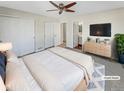 Main bedroom with a ceiling fan, large closets, and an en-suite bathroom at 1335 S Danube Way # 105, Aurora, CO 80017