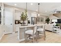 Bright, open kitchen with white cabinets, center island, and stainless steel appliances at 4588 S Versailles St # B, Aurora, CO 80015