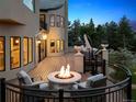 Inviting backyard deck with a cozy fire pit, comfortable seating, and elegant outdoor decor at 81 Falcon Hills Dr, Highlands Ranch, CO 80126
