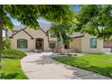Inviting front exterior with a paved walkway, lush landscaping, and a stately facade at 81 Falcon Hills Dr, Highlands Ranch, CO 80126