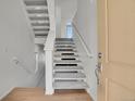Bright entryway featuring a staircase with modern design, carpeted steps, and neutral walls at 10124 Xanadu St, Commerce City, CO 80022