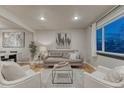 Bright living room featuring hardwood floors, modern furnishings and a large window at 6550 W 74Th Pl, Arvada, CO 80003