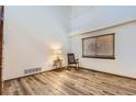 Bright, airy bedroom featuring wood floors, a window with blinds, and ample natural light at 11042 Blackwolf Ln, Parker, CO 80138