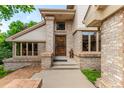 Brick home's entrance features a decorative door with brick pillars at 10227 Osceola Ct, Westminster, CO 80031