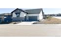 Charming home exterior features a two-car garage and professional landscaping at 5492 Woodroot Pt, Castle Rock, CO 80104