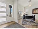 Bright home office space with modern desk, stylish rug, and large windows at 5492 Woodroot Pt, Castle Rock, CO 80104