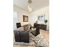 Modern office space with a sleek black desk, decor, and statement lighting fixture at 5492 Woodroot Pt, Castle Rock, CO 80104