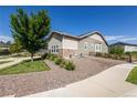 Exterior shot of the side of the house, showcasing the gravel landscaping and fenced yard at 26722 E Peakview Pl, Aurora, CO 80016