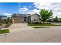Beautiful exterior featuring a two-car garage, stone accents, and a well-manicured lawn at 26722 E Peakview Pl, Aurora, CO 80016