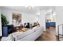 Bright living room with modern decor, hardwood floors, stylish furniture, and an open concept layout at 9315 Field Ln, Westminster, CO 80021