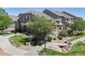 Inviting townhome with mature landscaping, rock garden, and charming walkway, creating a serene outdoor space at 4718 Raven Run, Broomfield, CO 80023