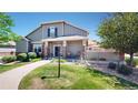 Beautiful two-story home featuring a cozy front porch and well-manicured lawn on a sunny day at 4718 Raven Run, Broomfield, CO 80023