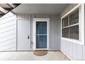 Close-up of front door with welcome mat, screen door and outside closet at 7185 S Gaylord St # G13, Littleton, CO 80122