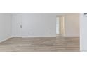 Spacious living room featuring sleek floors and a hallway, bathed in natural light at 7185 S Gaylord St # G13, Littleton, CO 80122