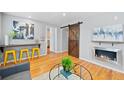 Stylish living area with barn door accent, modern fireplace, and open layout at 2545 W 45Th Ave, Denver, CO 80211