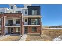 Modern brick townhome with balcony and walkway at 9633 Browns Peak Cir, Littleton, CO 80125