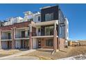 Modern brick townhome with two-car garage and balcony at 9633 Browns Peak Cir, Littleton, CO 80125