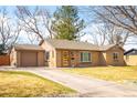 Wide driveway leading to this brick home with a cheerful yellow front door at 3925 Newland St, Wheat Ridge, CO 80033