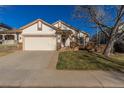 Two-car garage and a wooden deck at 9488 Brook Ln, Lone Tree, CO 80124