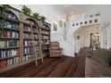 Grand living room featuring a floor to ceiling bookshelf and staircase leading to the second floor at 10938 Mcclellan Rd, Parker, CO 80134