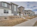 Row of townhomes showcasing modern design, stone accents, and landscaping at 16700 Alzere Pl, Parker, CO 80134