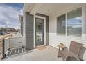 Cozy front porch with seating and a modern front door at 16700 Alzere Pl, Parker, CO 80134