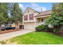 Charming two-story home with a well-manicured lawn, two car garage, and lovely curb appeal at 21052 E 45Th Ave, Denver, CO 80249