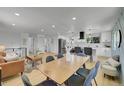 Open layout showcasing the kitchen, dining area, and living space with a modern aesthetic and natural light at 1173 Xenon St, Golden, CO 80401