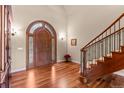 Elegant foyer with hardwood floors, arched doorway, and staircase at 11406 Conifer Ridge Dr, Conifer, CO 80433