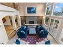 Open floor plan with fireplace and large windows overlooking a natural wooded area at 11406 Conifer Ridge Dr, Conifer, CO 80433