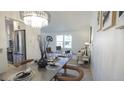 Open-concept living space combining dining and living areas with modern decor and ample natural light from large windows at 13833 W 68Th Ave, Arvada, CO 80004