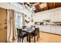 Bright eat-in kitchen featuring modern ceiling fan, vaulted ceilings, and a cozy dining space at 7948 Stuart St, Westminster, CO 80030
