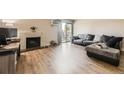 Cozy living room with modern flooring, fireplace, and sliding door access to the outside at 381 S Ames St # F208, Lakewood, CO 80226