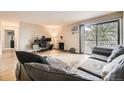 Spacious living room features a fireplace, balcony access, and ample natural light at 381 S Ames St # F208, Lakewood, CO 80226