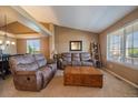 Cozy living room with vaulted ceilings, neutral tones, plush seating, and lots of natural light at 1758 Parkdale N Cir, Erie, CO 80516