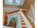 View of a wooden staircase with white railings at 3233 Osage St # 2A, Denver, CO 80211