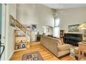 Bright living room featuring high ceilings, hardwood floors, and a staircase, perfect for Gathering gatherings at 20530 Parker Vista Cir, Parker, CO 80138