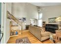 Bright living room featuring hardwood floors, high ceilings, and a cozy seating area with a piano at 20530 Parker Vista Cir, Parker, CO 80138
