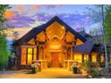 Grand entrance boasts a soaring gable, stonework, and warm lighting at 41 Stillson Placer Ter, Breckenridge, CO 80424