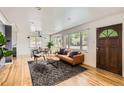Bright living room featuring hardwood floors, modern furniture, and plenty of natural light at 900 Locust St, Denver, CO 80220