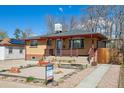 Attractive exterior of a well-maintained home, showcasing the lawn, landscaping, and real estate signage at 2060 S Lowell Blvd, Denver, CO 80219