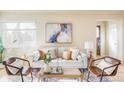 Cozy living room with a neutral color palette, stylish furniture, and natural light from a window at 4215 W Byron Pl, Denver, CO 80212