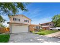 Charming two-story home featuring a lush lawn, brick accents, and an attached two car garage at 7276 W 83Rd Way, Arvada, CO 80003