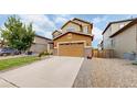 Two-story house with a large yard, driveway, and attached garage at 11828 Churchfield St, Parker, CO 80134