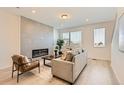 Modern living room with a decorative fireplace, gray sofa, and wood-look floors at 374 North Geneva, Aurora, CO 80010