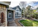 Inviting front entrance with stone accents and a neatly landscaped garden area at 18572 E Tanforan Pl, Aurora, CO 80015