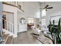 Bright living room with high ceilings, an open layout and hardwood-style floors at 18572 E Tanforan Pl, Aurora, CO 80015