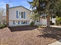 Traditional home with a manicured front yard and an attached garage with a private driveway at 17900 E Mexico Dr, Aurora, CO 80017